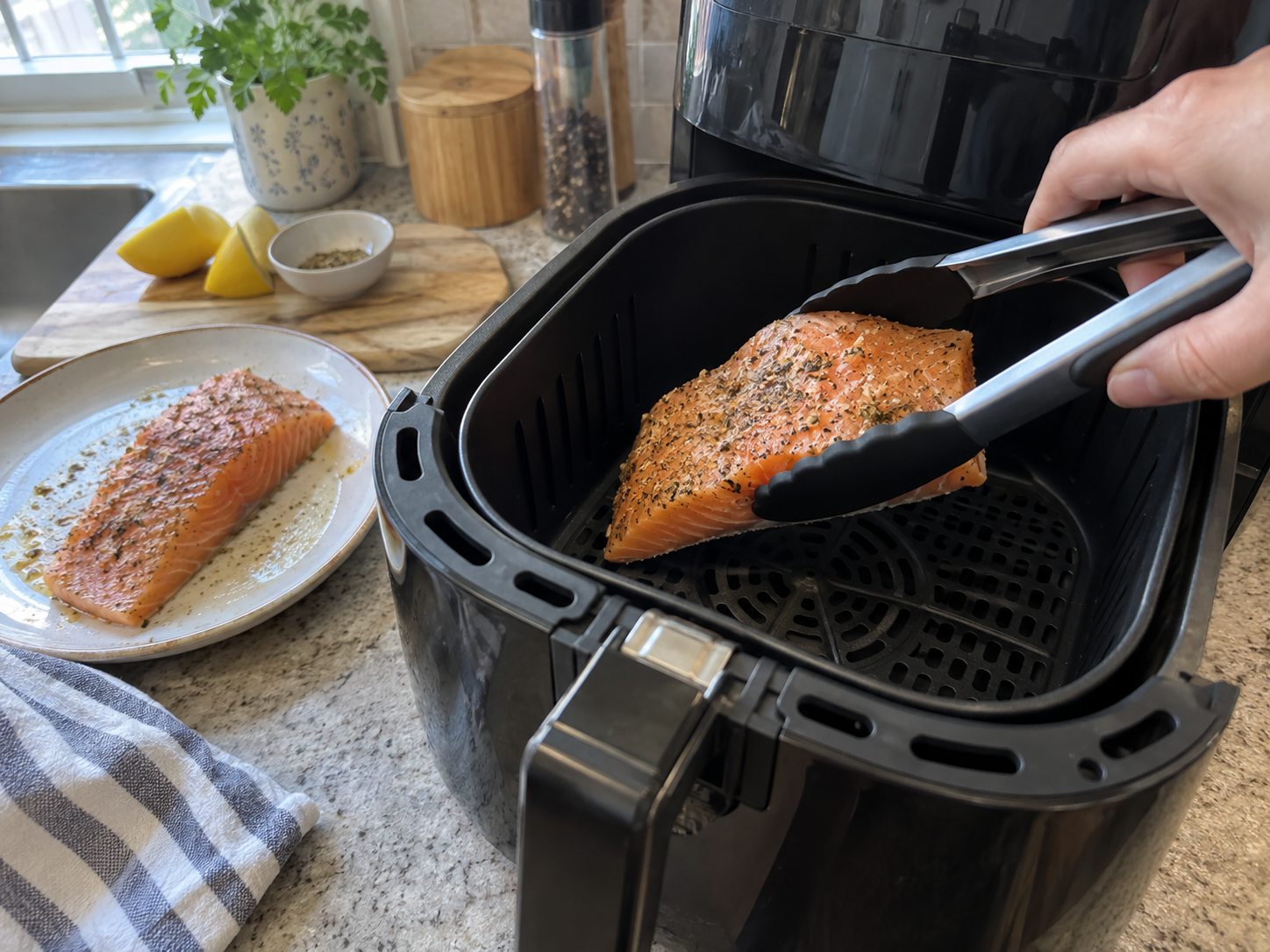 Seasoned salmon fillets cooking in an air fryer basket