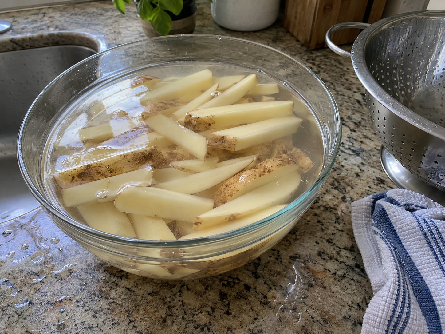 Fresh-cut potatoes tossed with oil and seasoning before baking into French fries.